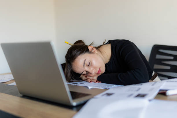 istock Tired Woman Working Extra Hours at The Office 2184765692