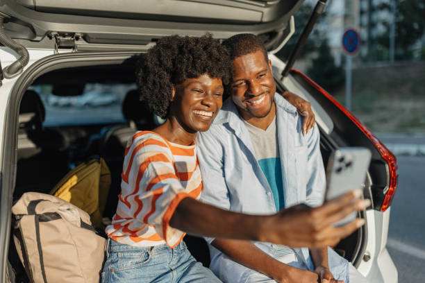 istock Couple taking a selfie in car's open trunk area 2184765728