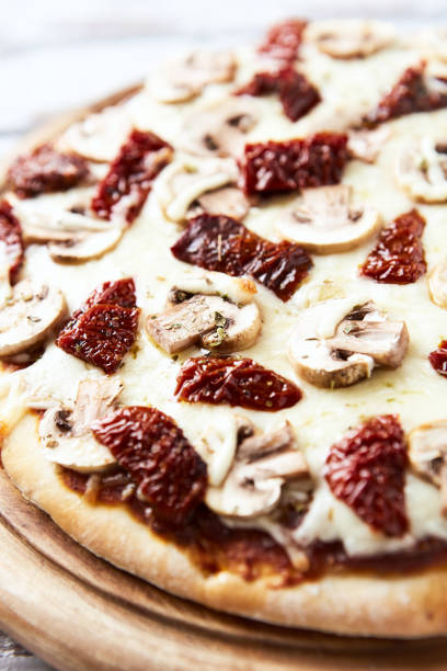 Pizza with mozzarella cheese and marinated tomatoes. Close up