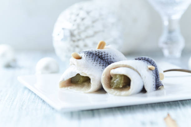 Traditional dutch herring with pickles and onion isolated on white background