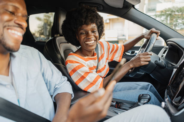 istock Couple Enjoying a Joyful Ride in Modern Car Together 2184765995