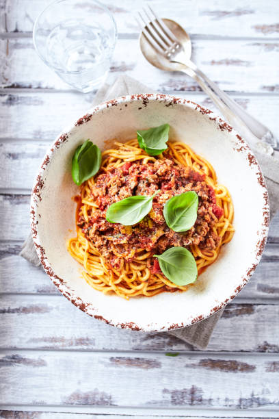 istock Spaghetti bolognese and fresh Basil o bright background. Close up. 2184766046