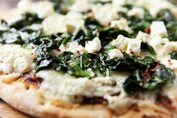 istock Pizza with mozzarella cheese and spinach. Dark wooden background. Close up. 2184766162