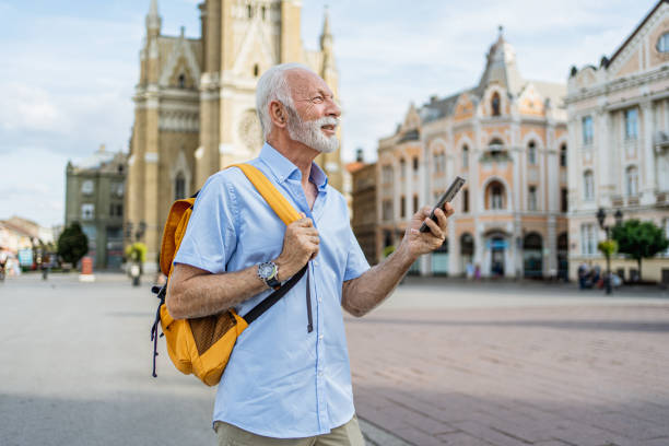 istock Senior man tourist using phone in the city 2184766615