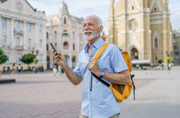 istock Senior man tourist using phone in the city 2184766682