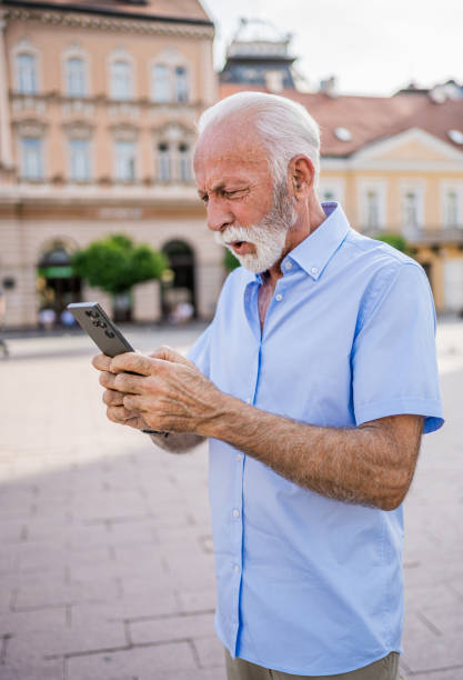 istock Senior man using a smartphone outdoors 2184766997