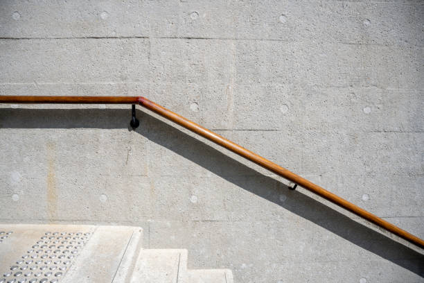 Handrails at the edge of cement wall stairs