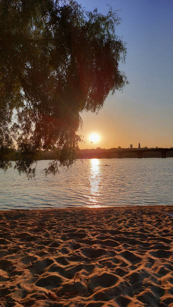 istock Golden Sunset Over Tranquil Riverside Beach 2184768244