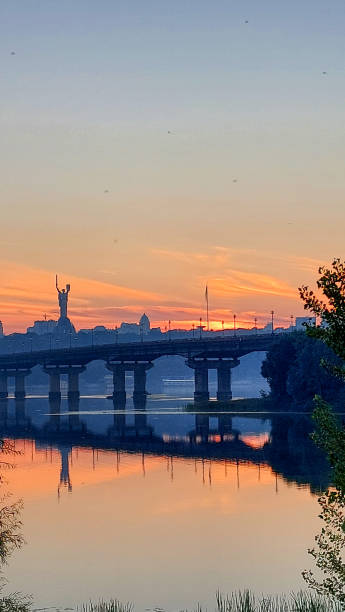 istock Sunset over Kyiv with Reflection of Bridge and Monument 2184768701