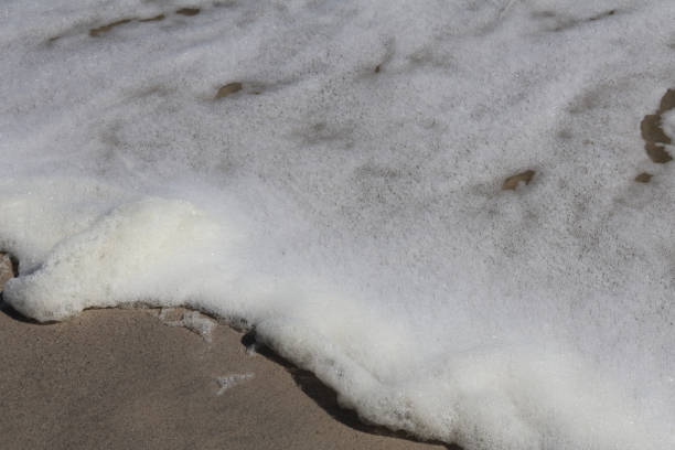 istock White Ocean Foam Gently Washing Over Sandy Shoreline 2184768852