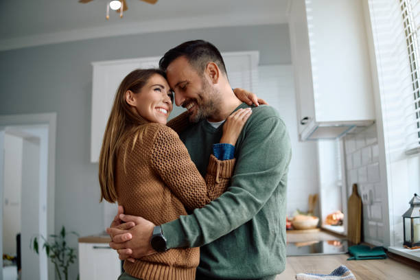 istock Happy couple in love embracing in the kitchen. 2184769691