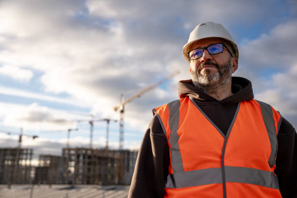 istock Construction Worker Wearing Safety Gear at Building Site 2184772969