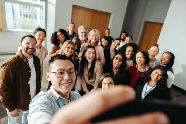 istock Diverse group taking a cheerful selfie at a successful seminar to capture a memorable moment of teamwork and collaboration 2184773123