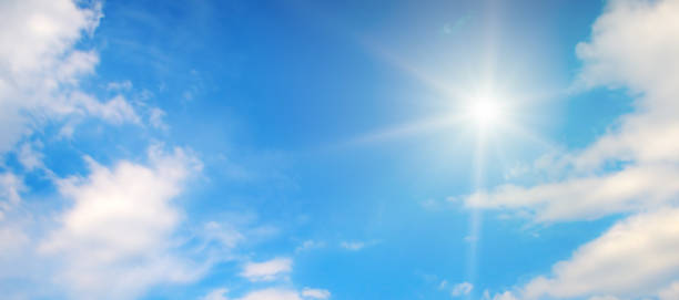 istock Blue sky with white clouds and bright sun. 2184773958