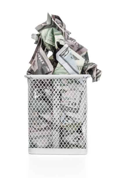 istock Crumpled dollar banknotes in trash basket on a white background 2184779104