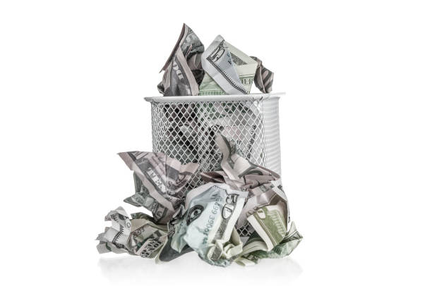 istock Crumpled dollar banknotes in trash basket on a white background 2184779111