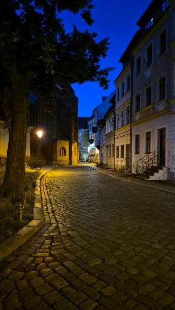 istock European night street with burning lantern 2184779597
