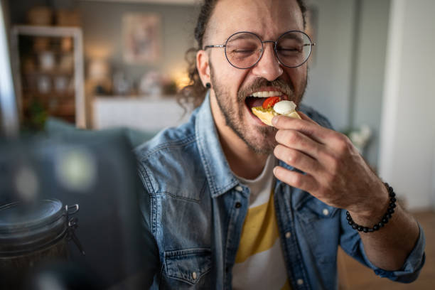 istock Hipster guy captures the moment with bruschetta in hand while taking a selfie 2184782059