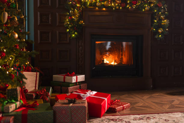 istock Classical Christmas decorated interior living room with fireplace. Christmas tree with red golden ornament decorations gift boxes. Modern classic style interior design apartment, Christmas eve at home 2184782235