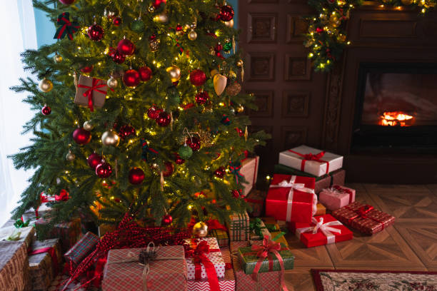 istock Classical Christmas decorated interior living room with fireplace. Christmas tree with red golden ornament decorations gift boxes. Modern classic style interior design apartment, Christmas eve at home 2184782257