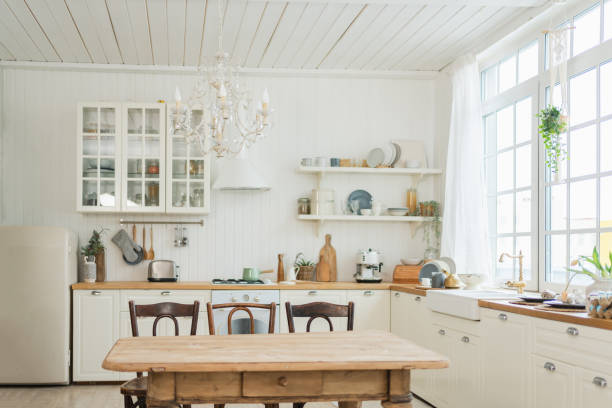 istock Empty white wooden kitchen interior with dining room. Scandinavian classic minimalistic bright kitchen with white and wooden details. Modern white kitchen clean contemporary style interior design. 2184782698