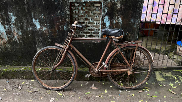 Old Bicycle in the road side wall