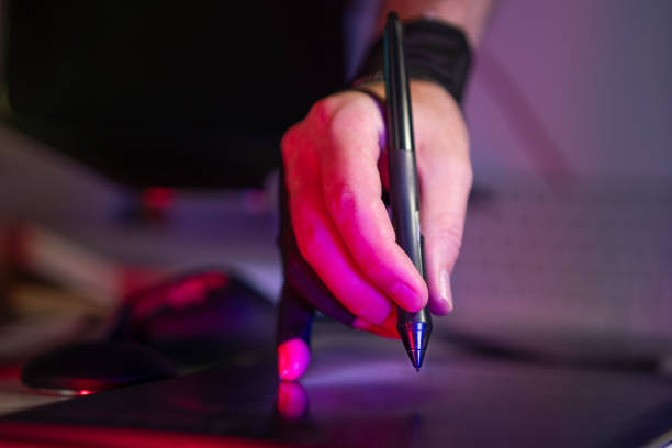 istock hand holding digital stylus on graphic tablet 2184784504