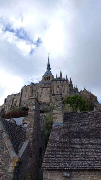 istock Majestic castle atop a hill with cloudy sky overhead 2184785099