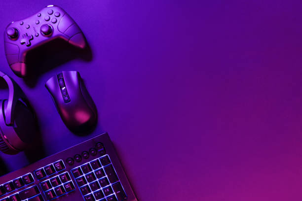 istock Gaming gadgets on illuminated purple desk 2184785197
