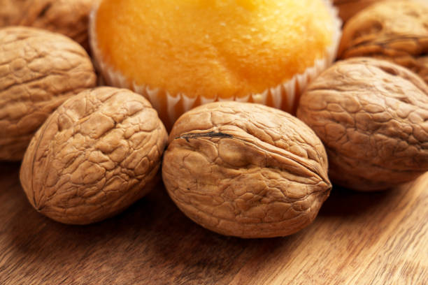 Lots of big nuts. Walnuts peeled on a pink background.