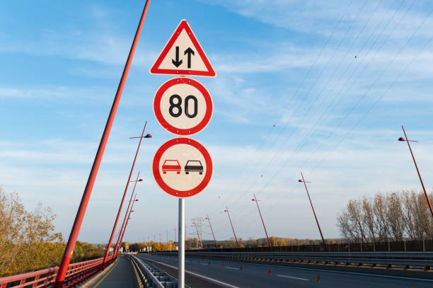 a red and white barrier to protect pedestrians in selective focus