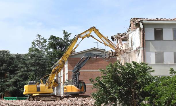 istock Two heavy excavators demolishing a building for an urban redevelopment 2184786236