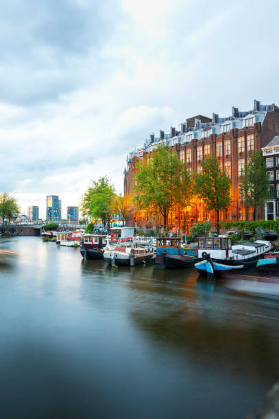 Long exposure photo of boats in the Amsterdam canals during the sunset