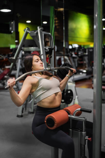 istock Fitness woman doing back exercises in gym. 2184788261