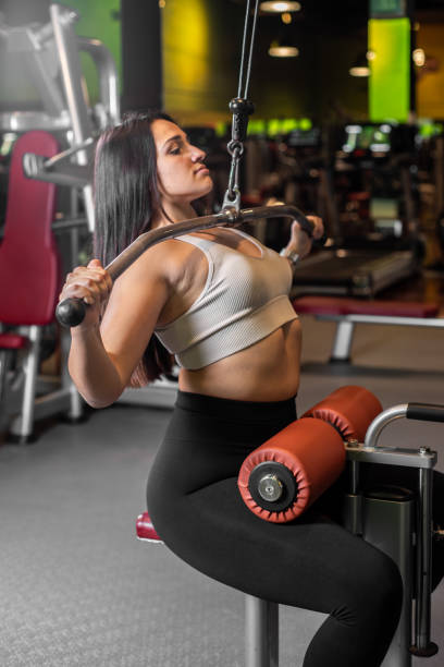 istock Fitness woman doing back exercises in gym. 2184788371