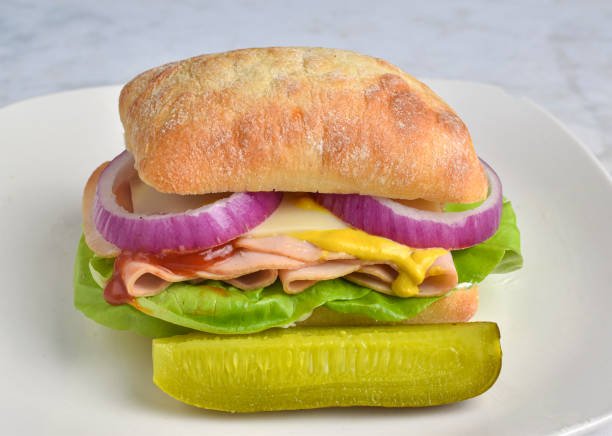 istock turkey sandwich  with lettuce , onions and swiss cheese 2184788415