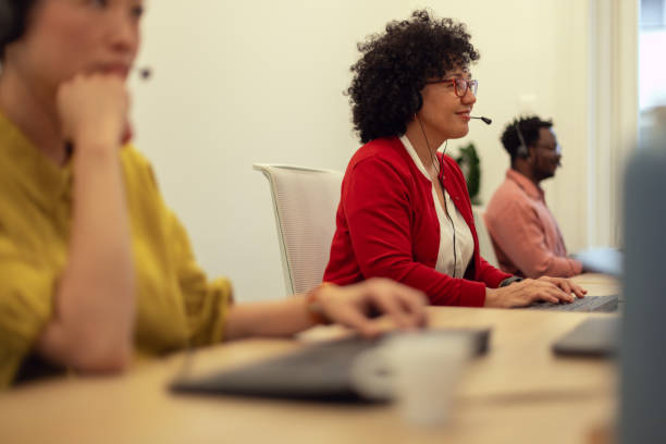 istock A multi-ethnic team of call center representatives sitting next to each other in the same office while talking to international customers 2184792694