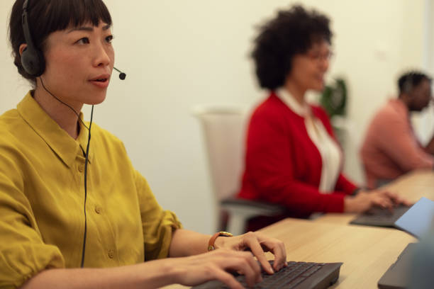istock A multiracial team of call center representatives sitting next to each other in the same office while talking to international customers 2184792711