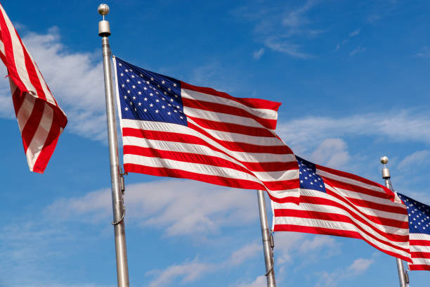 istock Rows of American flags waving against a blue sky 2184792892
