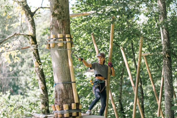 istock A Tree Climber Fully Engaged in Thrilling Adventure Activity in the Great Outdoors of Nature 2184793903