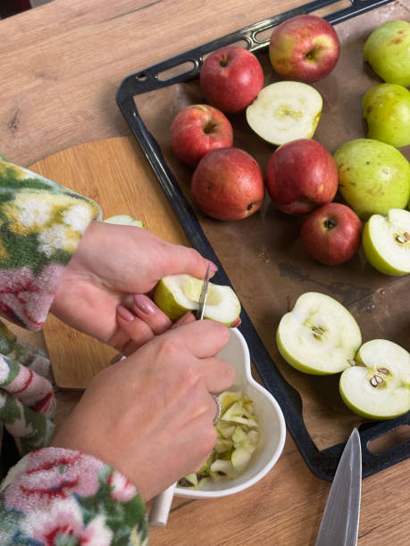 istock A woman is slicing apples. She is making fruit leather from apple puree. 2184794279
