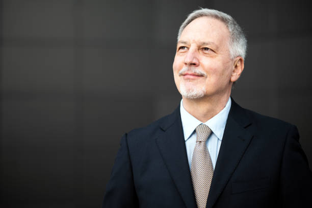 istock Senior businessman looking up with hope and confidence 2184796437