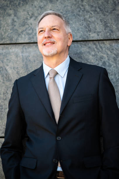istock Smiling senior businessman looking up with hope and confidence 2184796453