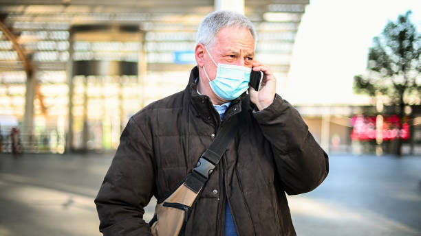 istock Senior businessman wearing protective face mask making a phone call 2184797501