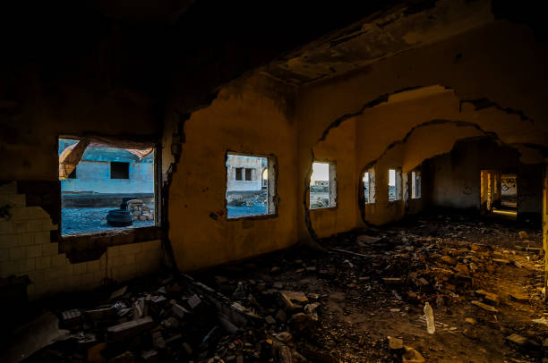 istock A large, empty room with a lot of debris and broken glass 2184797591