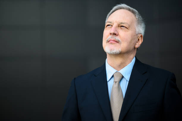 istock Senior businessman looking up with hope and confidence 2184797724