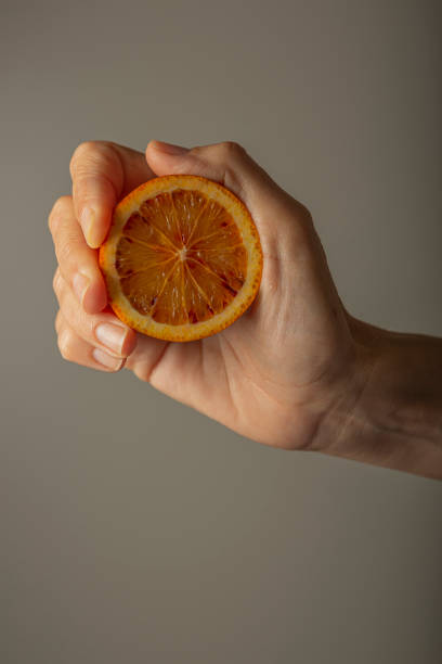 istock Hand holding a circular slice of orange against the light 2184798049