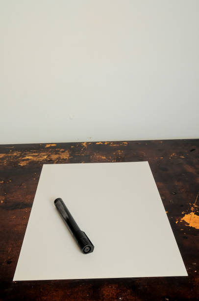 istock A pen is sitting on a piece of paper on a table 2184804330
