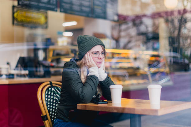 istock Woman Holding Coffee Cup in Coffee Shop 2184804781