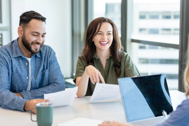 istock Young woman asks banker question about home loan 2184805860